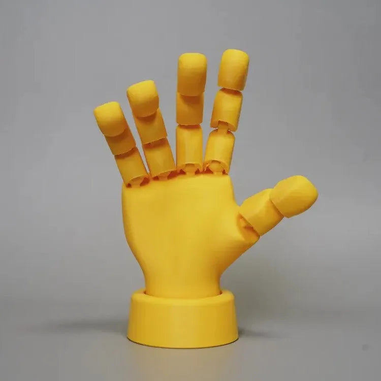 Yellow PLA plastic hand ornament with movable finger joints measuring 5 x 5.38 x 7.5 cm
