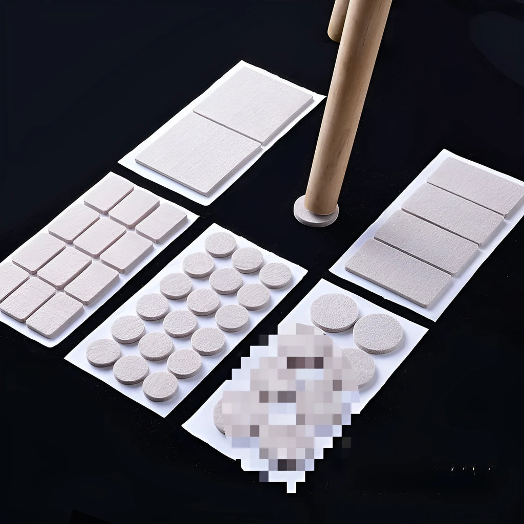 Assorted beige plastic furniture leg protectors in round and square shapes on hardwood floor