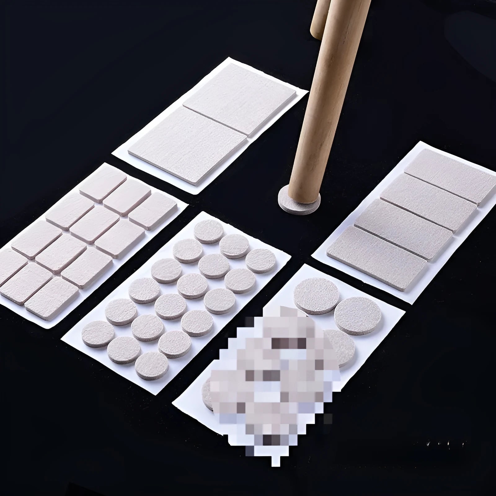 Assorted beige plastic furniture leg protectors in round and square shapes on hardwood floor