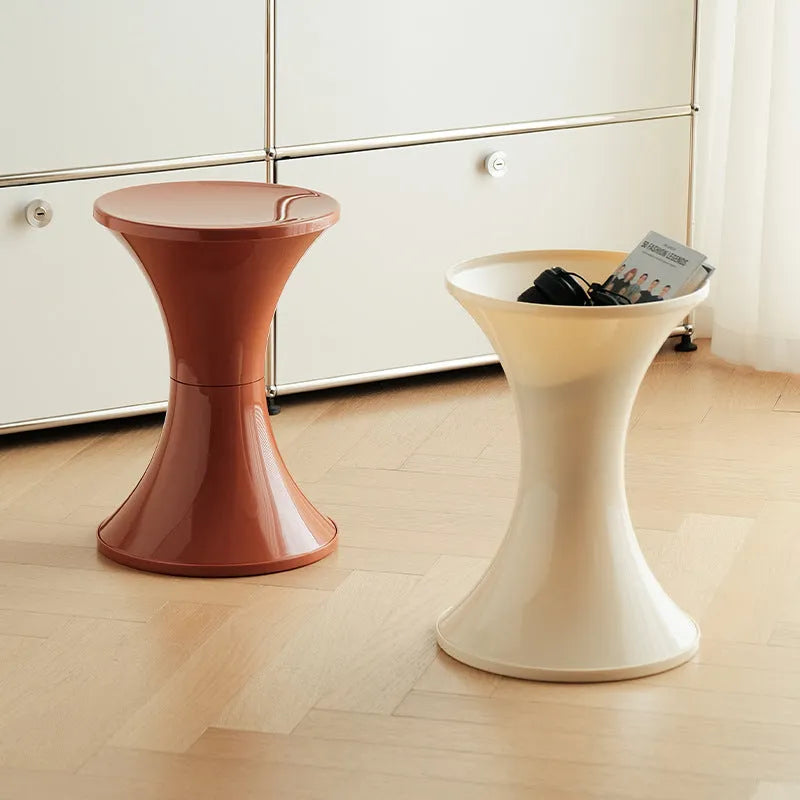 A plastic hourglass-shaped shoe changing stool in one of five colour options.
