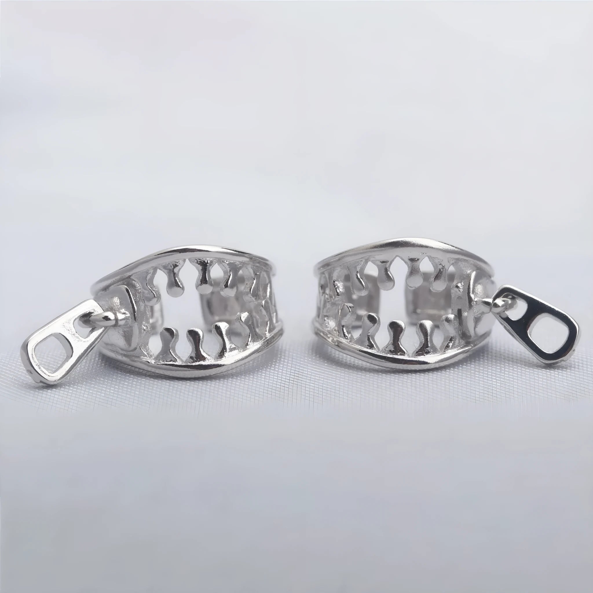 Copper geometric ear clips with zipper design detail in ES862 colour showing bone clip fastening