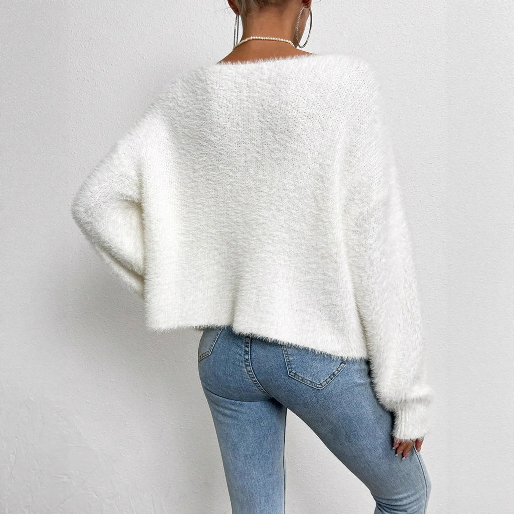 White women's V-neck cardigan sweater with bead knit texture on a hanger.