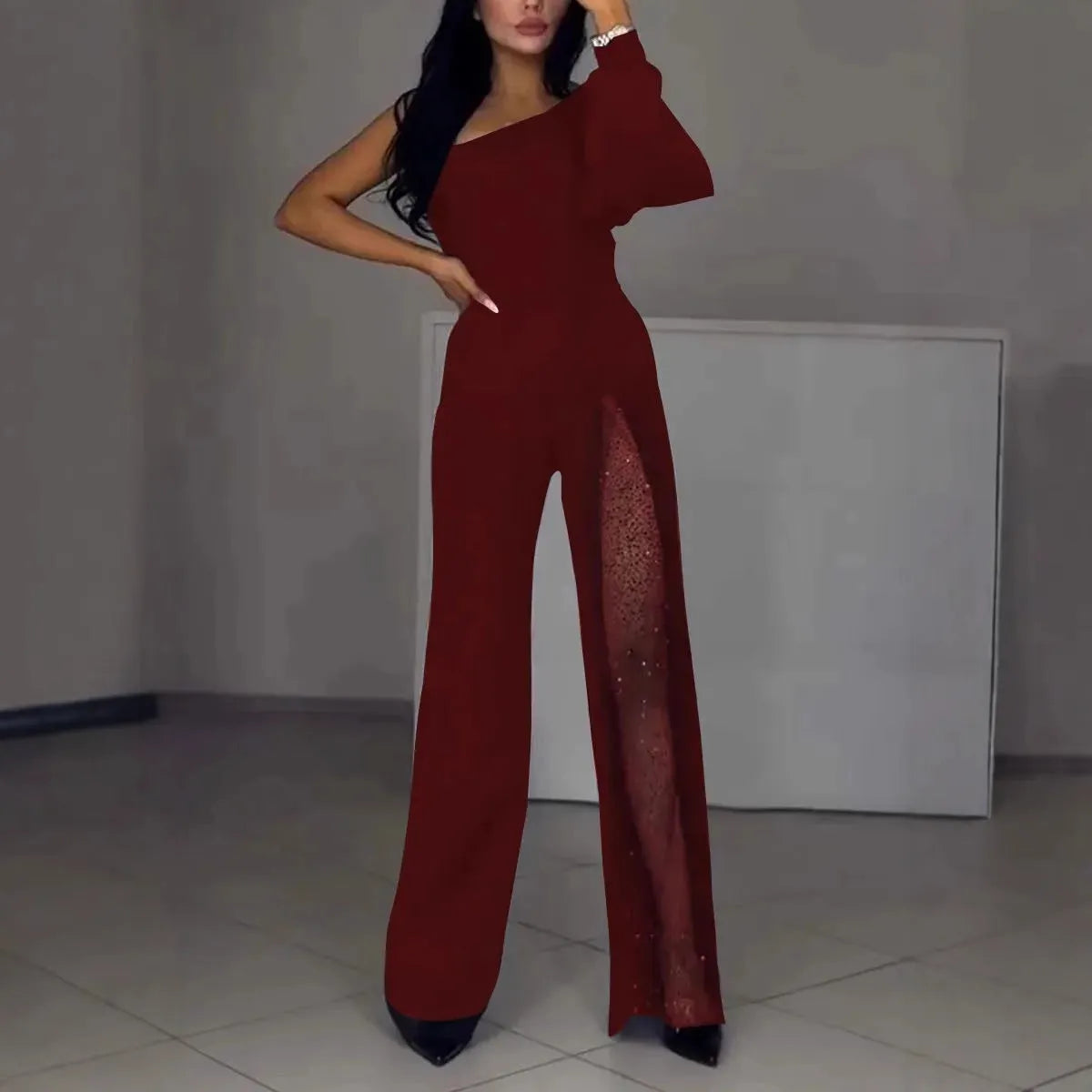 Black women's long sleeve jumpsuit with an oblique shoulder neckline and a high leg slit