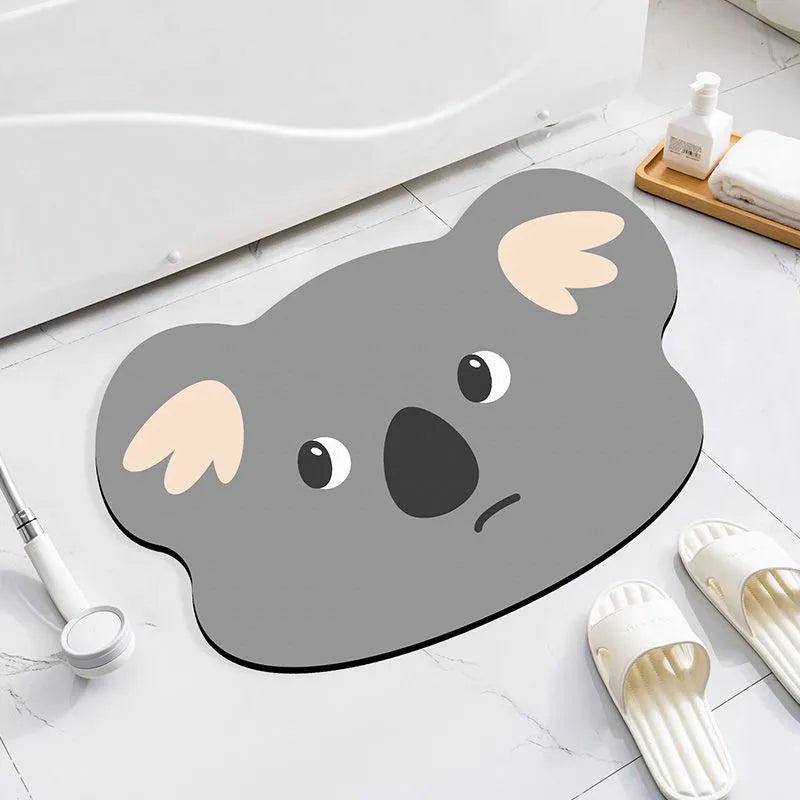 Colourful cartoon animal diatomite absorbent bathroom mat in alien shape on tiled floor.