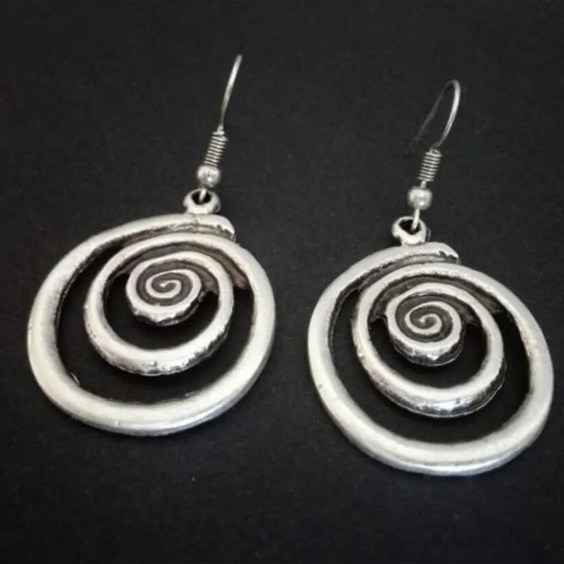 Silver geometric spiral earrings with a distressed retro finish, shown from the front.