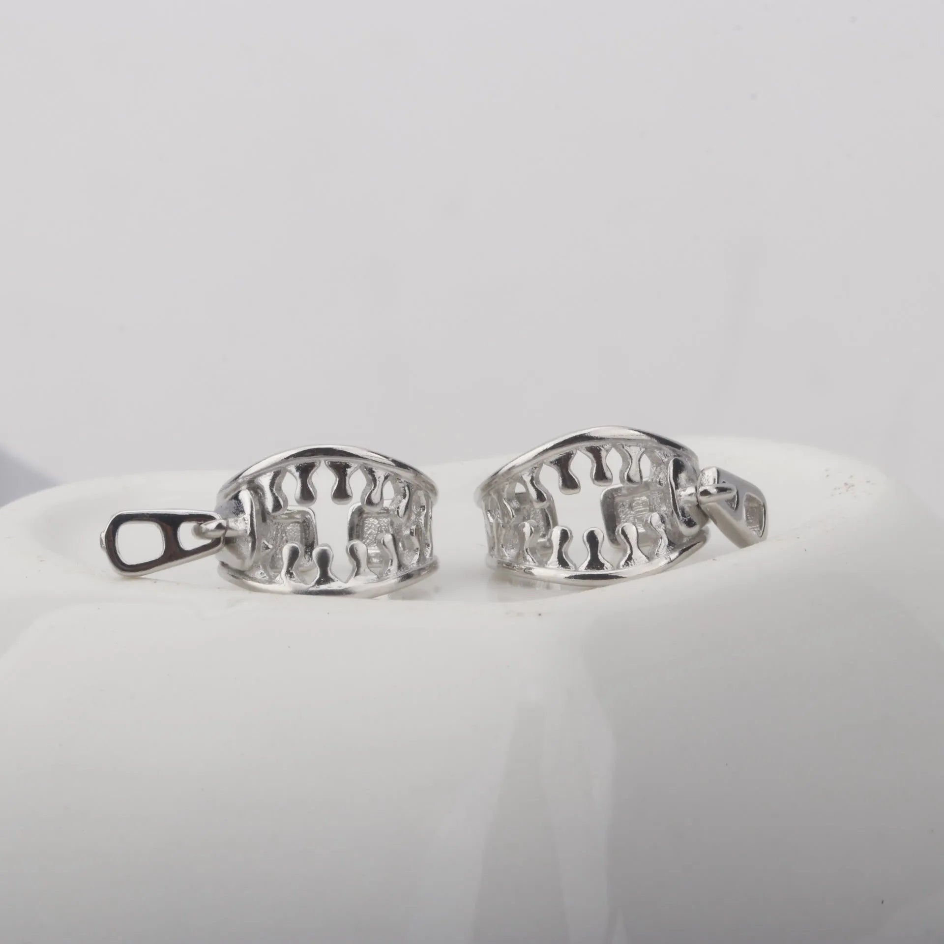 Copper geometric ear clips with zipper design detail in ES862 colour showing bone clip fastening