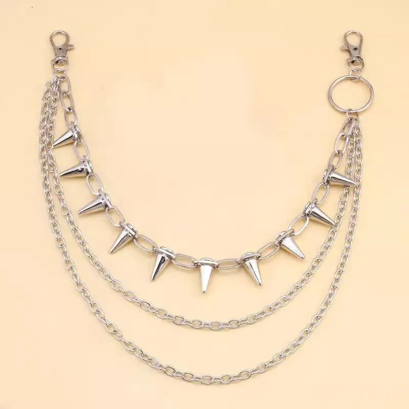Silver metal punk pants chain with rivets and zipper detail, shown draped on trousers.