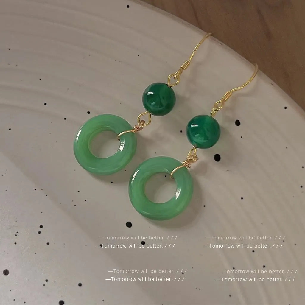 Green jade peace buckle shape earrings with zinc alloy construction and 14K gold plating