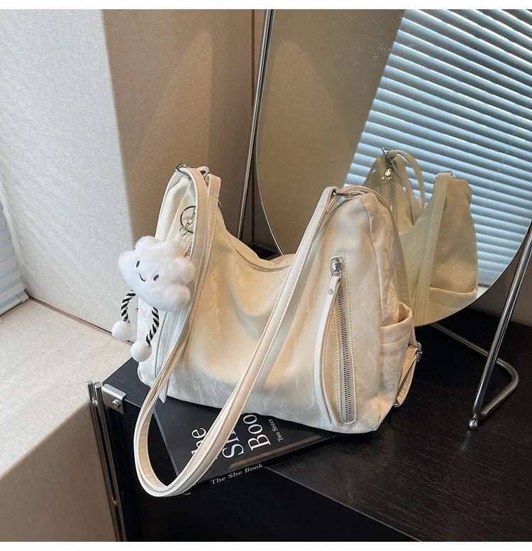 Women's soft PU fashion backpack with pendant accessory in black, milky white, silver or blue colour