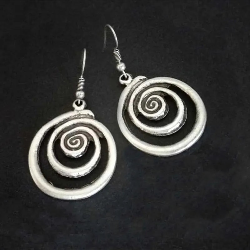 Silver geometric spiral earrings with a distressed retro finish, shown from the front.