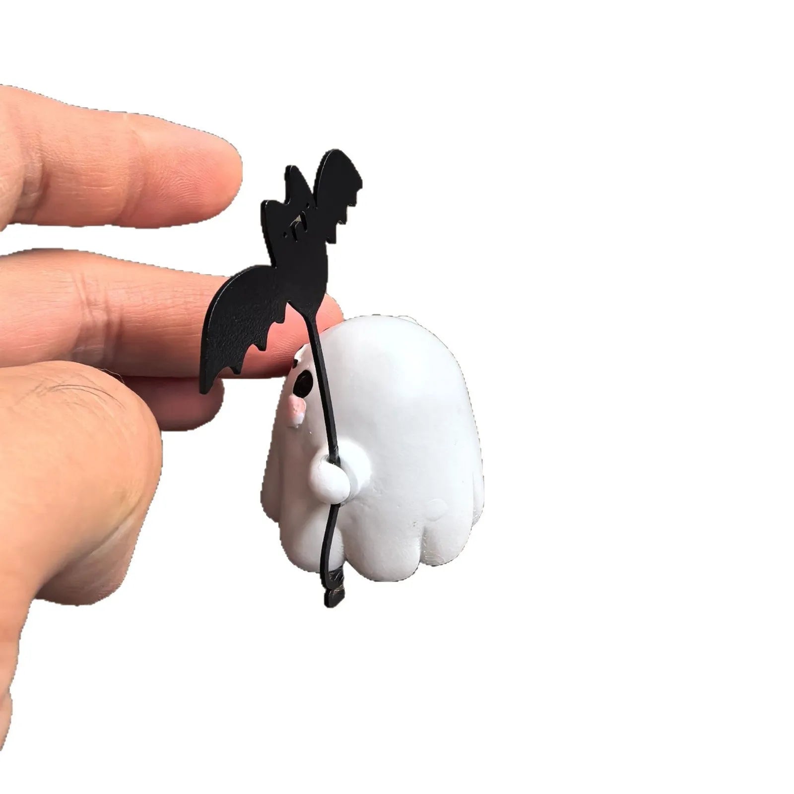 Small resin statue of a ghost walking a dog, holding a bat, for Halloween decoration.