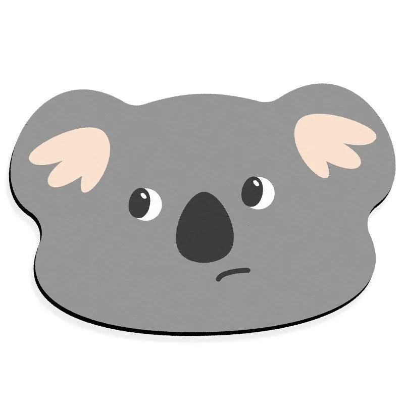 Colourful cartoon animal diatomite absorbent bathroom mat in alien shape on tiled floor.