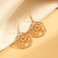 Gold tone donut spiral necklace, bracelet, and earrings set on a white background.