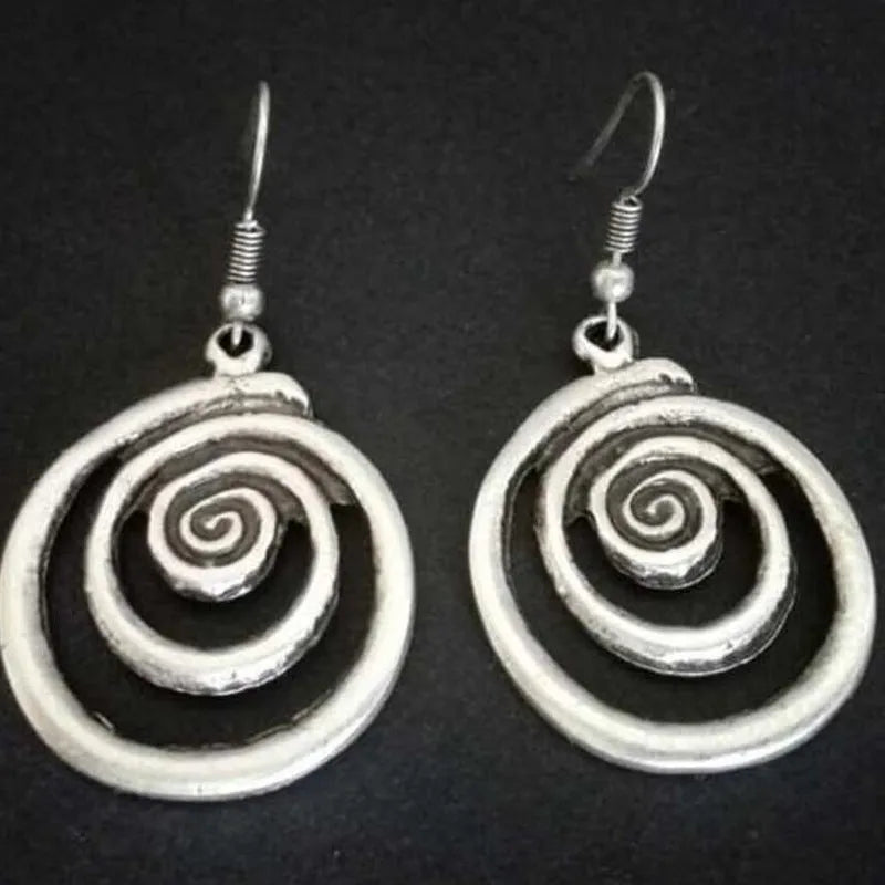 Silver geometric spiral earrings with a distressed retro finish, shown from the front.