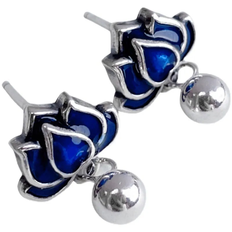 Close-up of alloy lotus ear studs with silver needle seedpod tassel design, showing 1.2cm width.