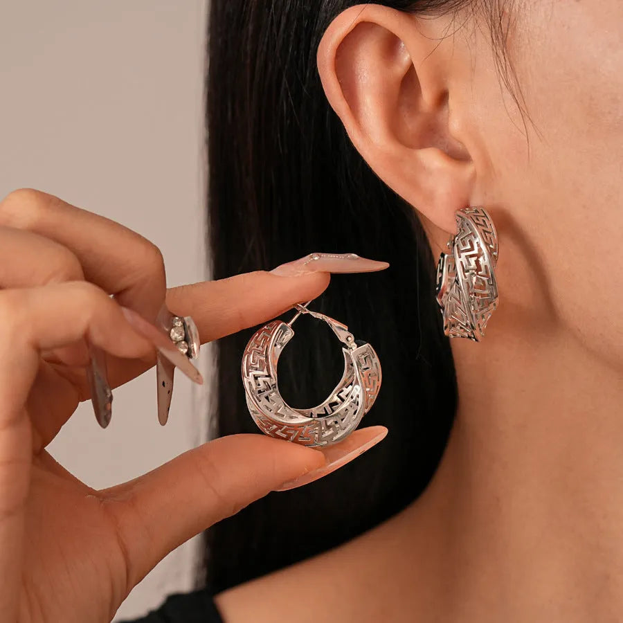 Geometric hollow stud earrings with twisted round design in silver or gold finish