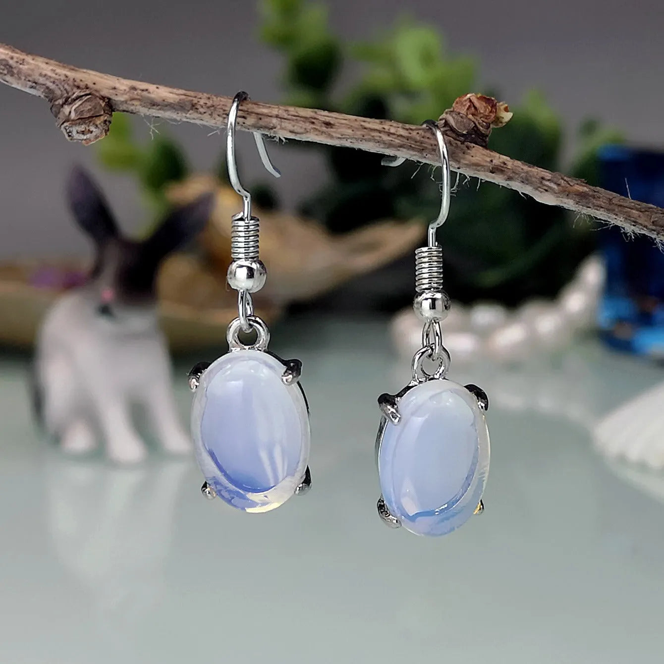 Moonlight White opal earrings with electroplated alloy construction in drop shape design