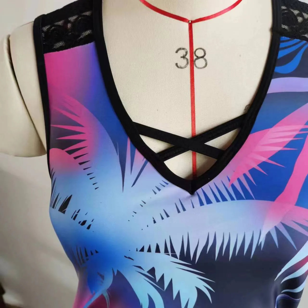 Women's blue two-piece swimsuit with floral lace print, showing top and briefs.