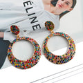 Colourful alloy drop earrings with large round pendants featuring diamond-effect detailing and cartoon-inspired styling