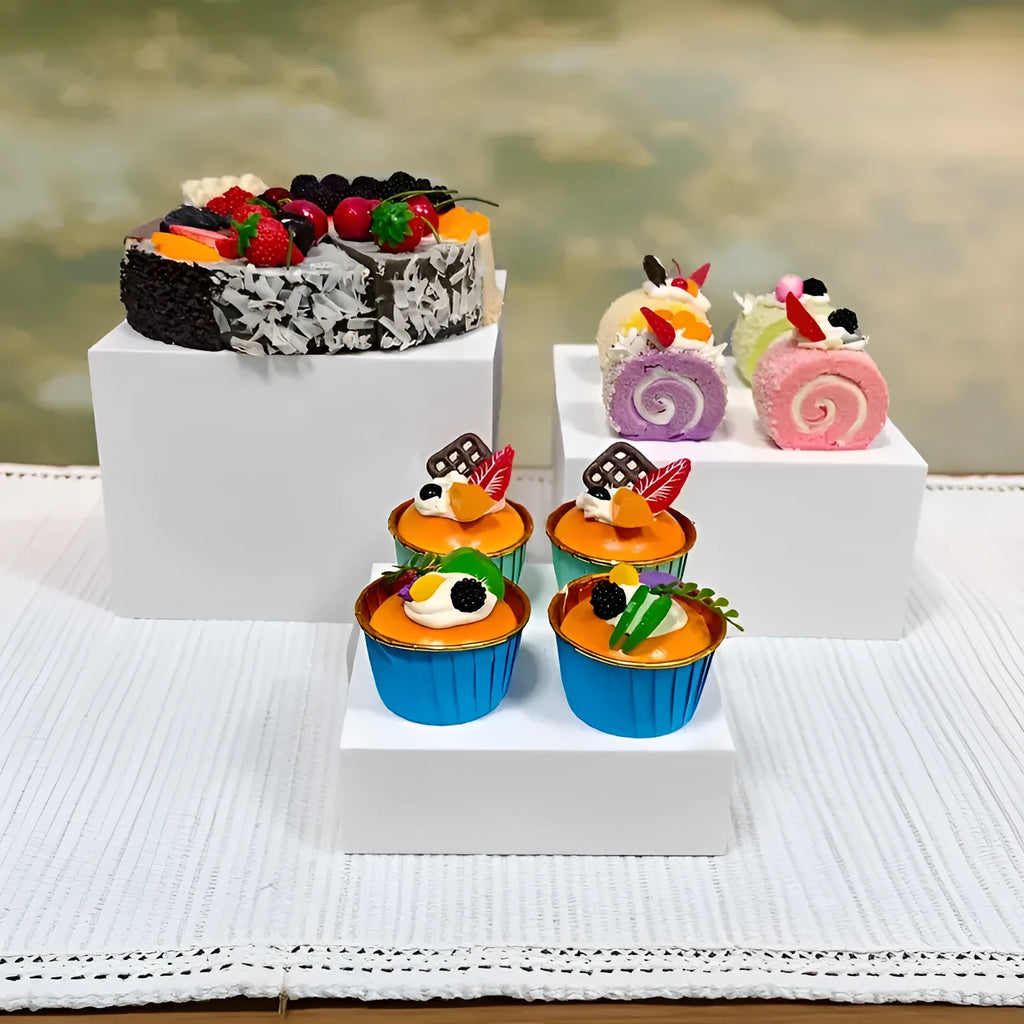White plastic suit cube dessert display stand with six-piece arrangement for tabletop cake presentation