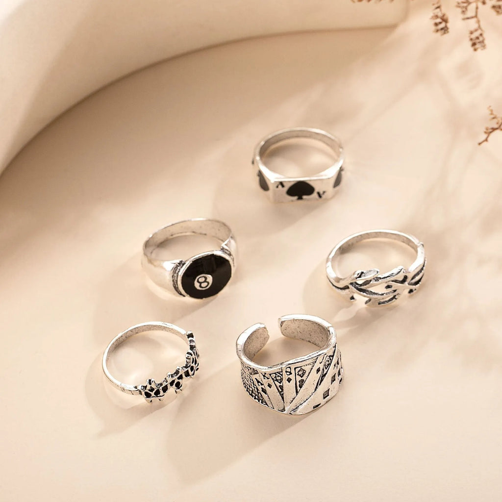 Black alloy poker ring with raised spade card design and adjustable band