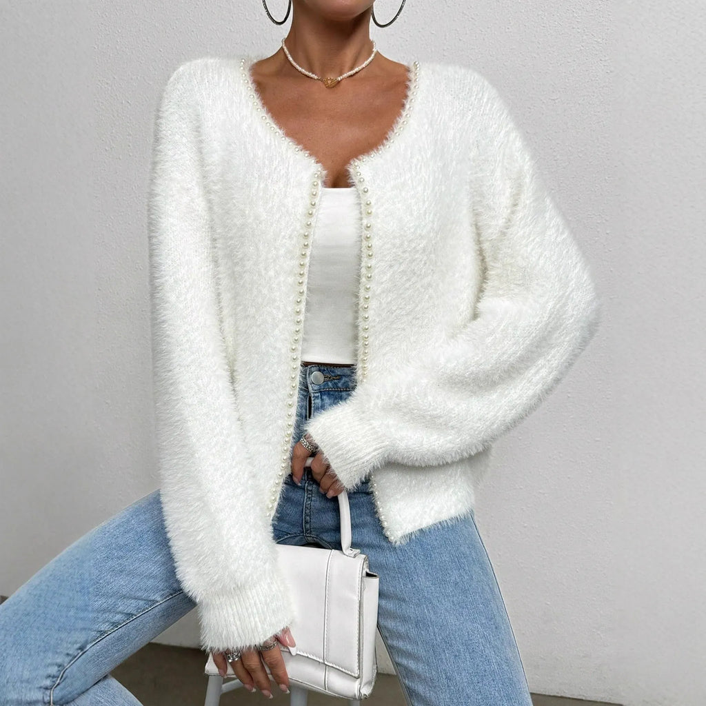 White women's V-neck cardigan sweater with bead knit texture on a hanger.