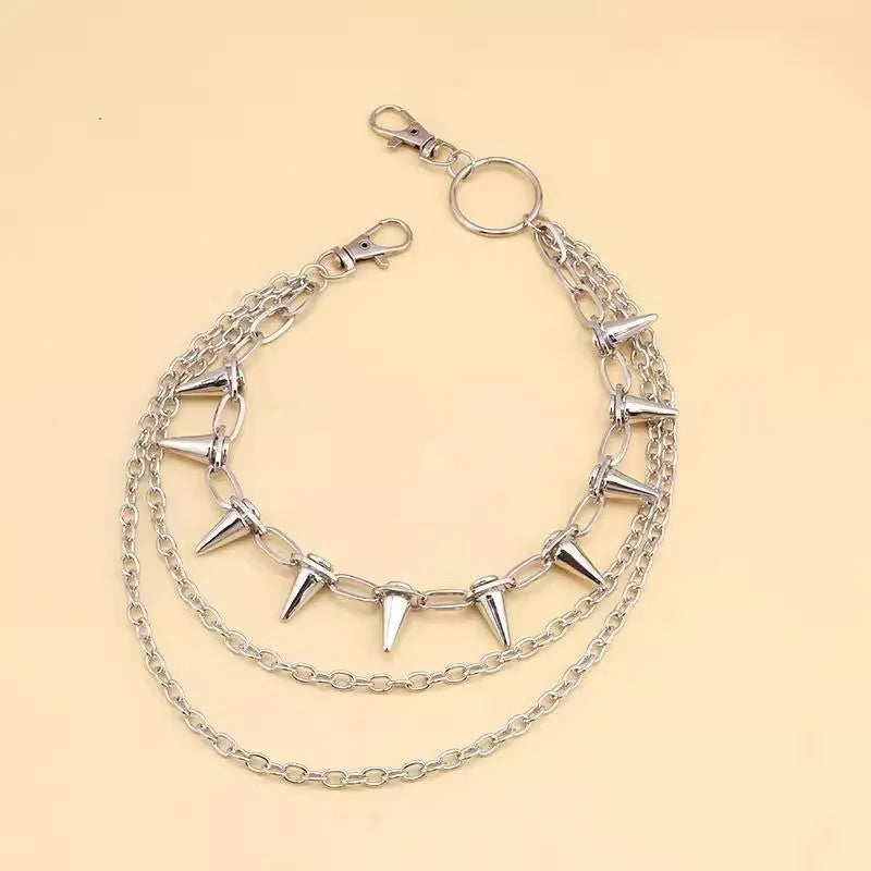 Silver metal punk pants chain with rivets and zipper detail, shown draped on trousers.