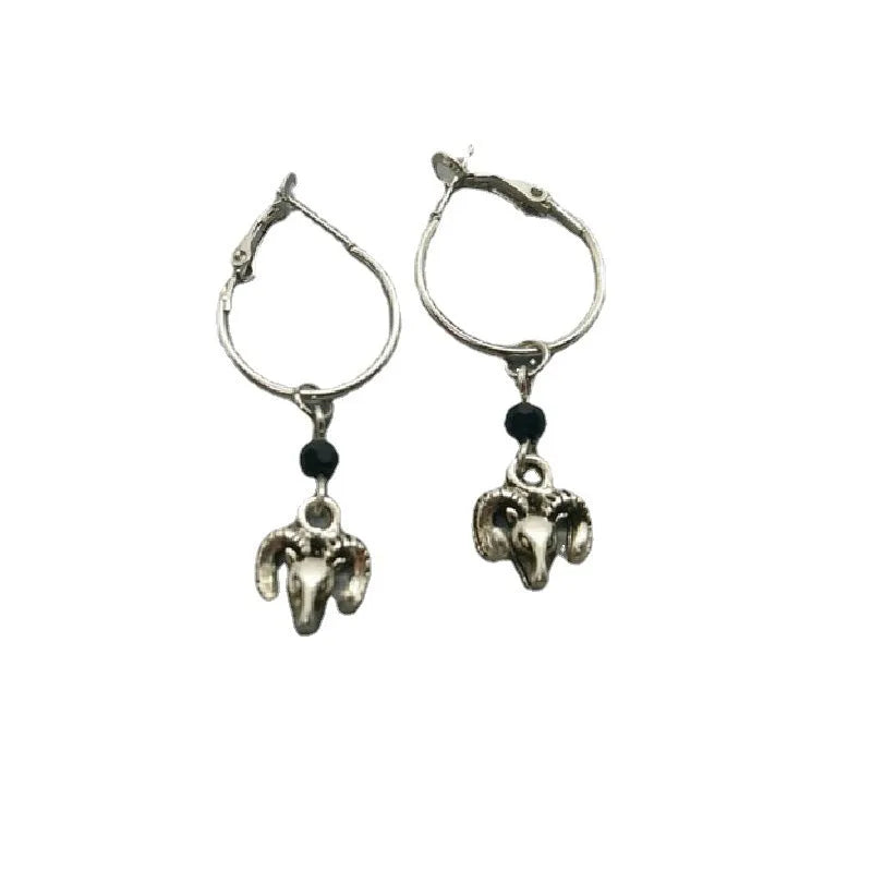 Women's silver tone alloy round ring earrings with geometric design on white background