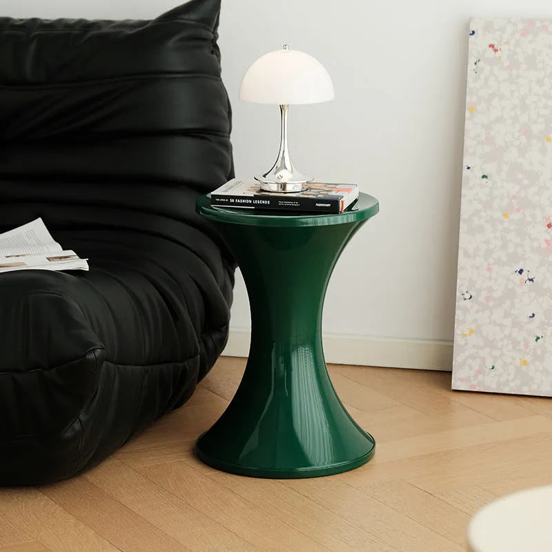 A plastic hourglass-shaped shoe changing stool in one of five colour options.