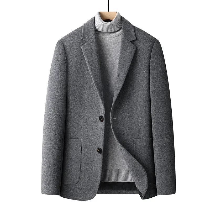 Men's slim fit wool suit jacket in grey on a hanger, showing notch lapel and button front.