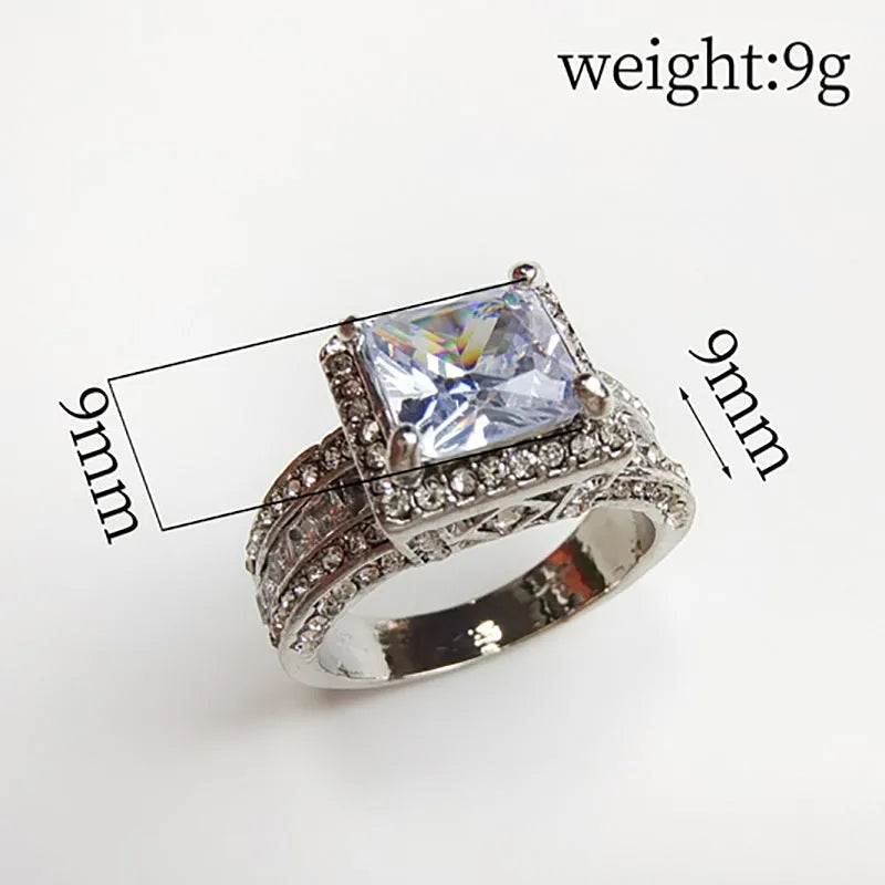Geometric silver fashion engagement ring for women in gold or white electroplated finish on a size chart.