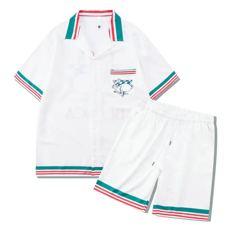 Men's plaid print beach outfit set with short sleeve shirt and pants on a hanger.