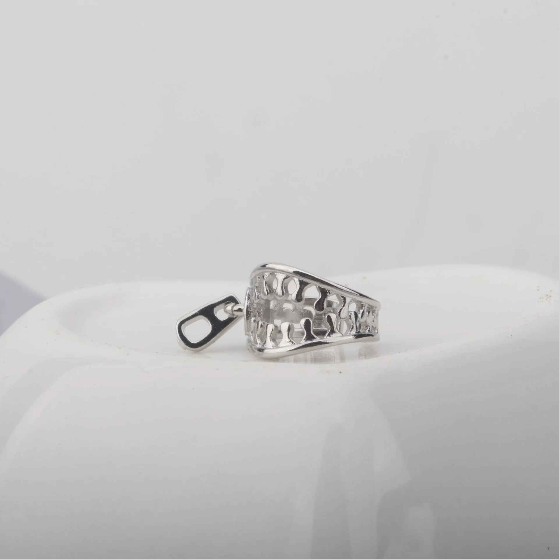Copper geometric ear clips with zipper design detail in ES862 colour showing bone clip fastening