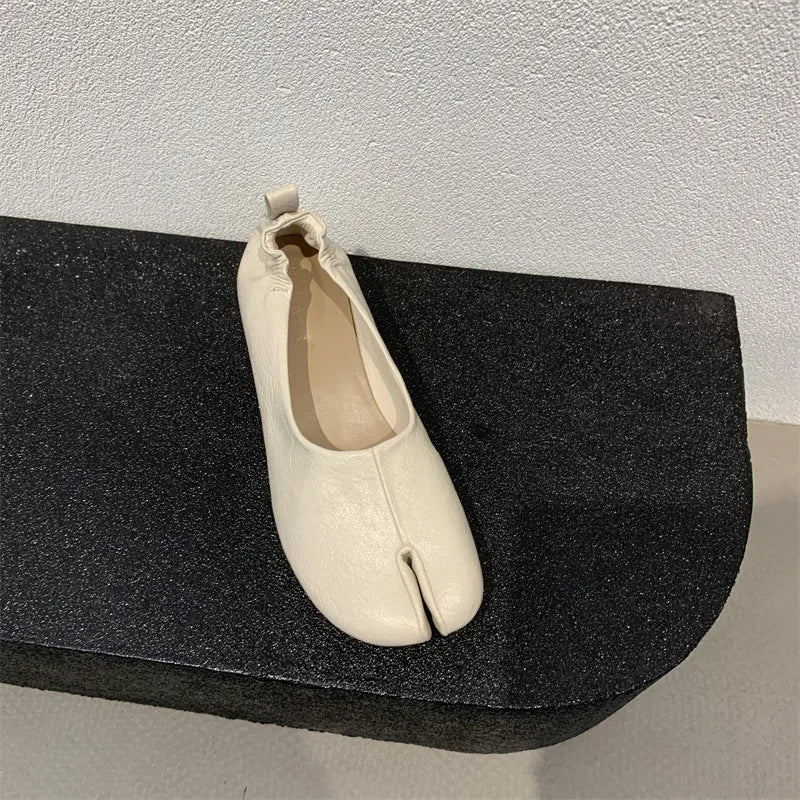 Women's round toe chunky heel pumps in apricot with a split toe horseshoe design and low heel.