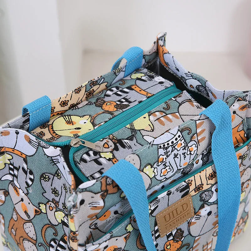 Women's printed canvas handbag with aluminium frame in multiple floral and animal print designs