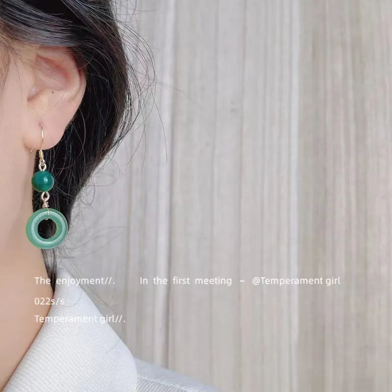 Green jade peace buckle shape earrings with zinc alloy construction and 14K gold plating