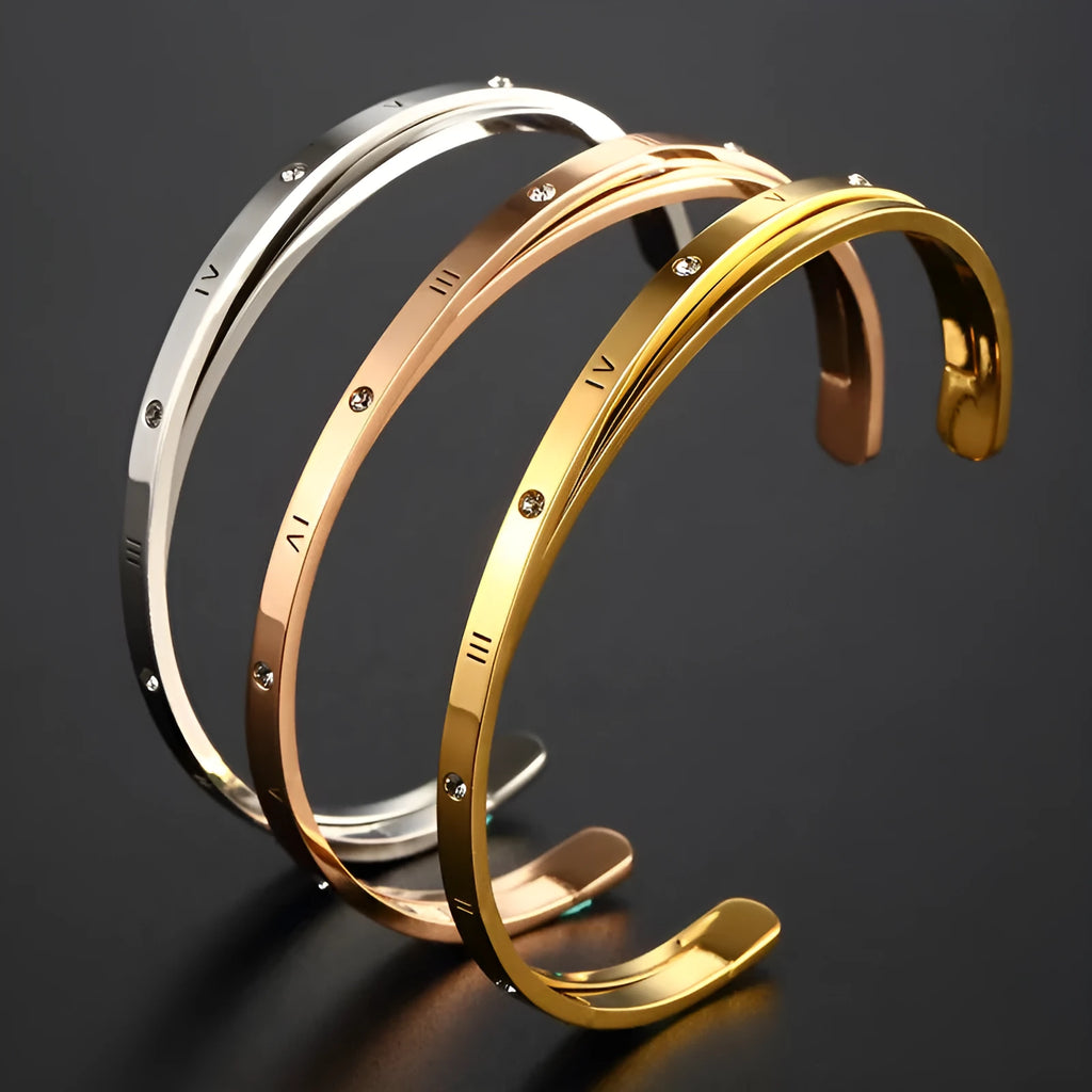 Open-ended stainless steel women's bracelet with inlaid zirconia stones in rose gold colour.