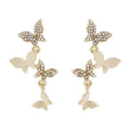 Gold colour butterfly earrings with four copper charms on hanging ear drops