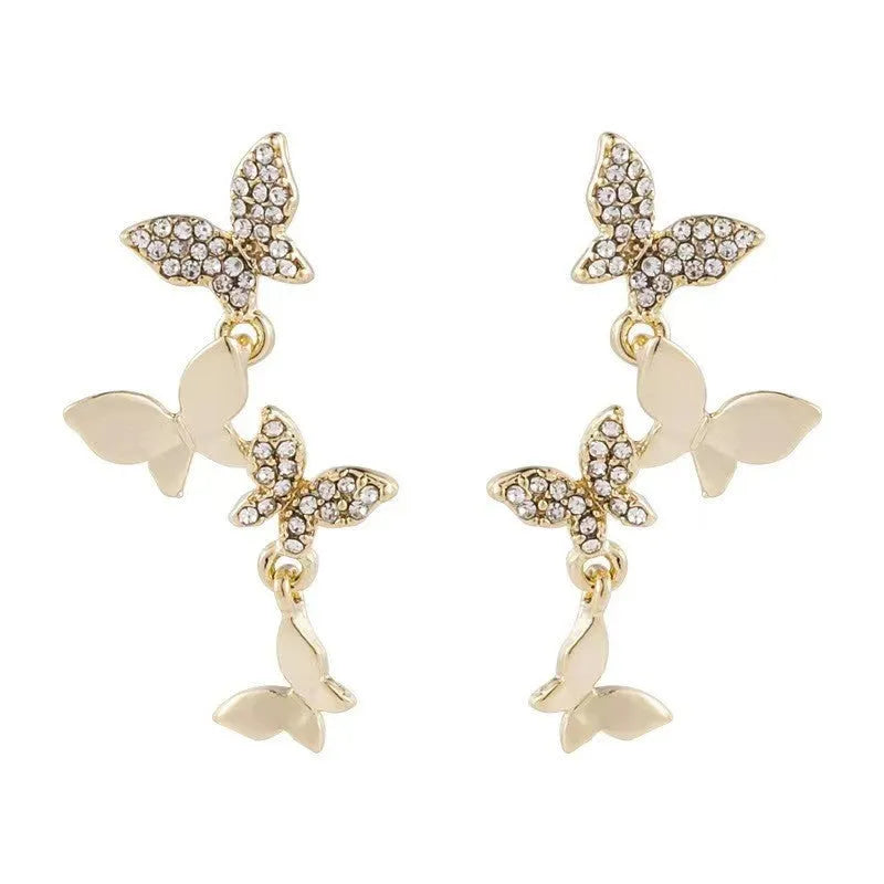 Gold colour butterfly earrings with four copper charms on hanging ear drops