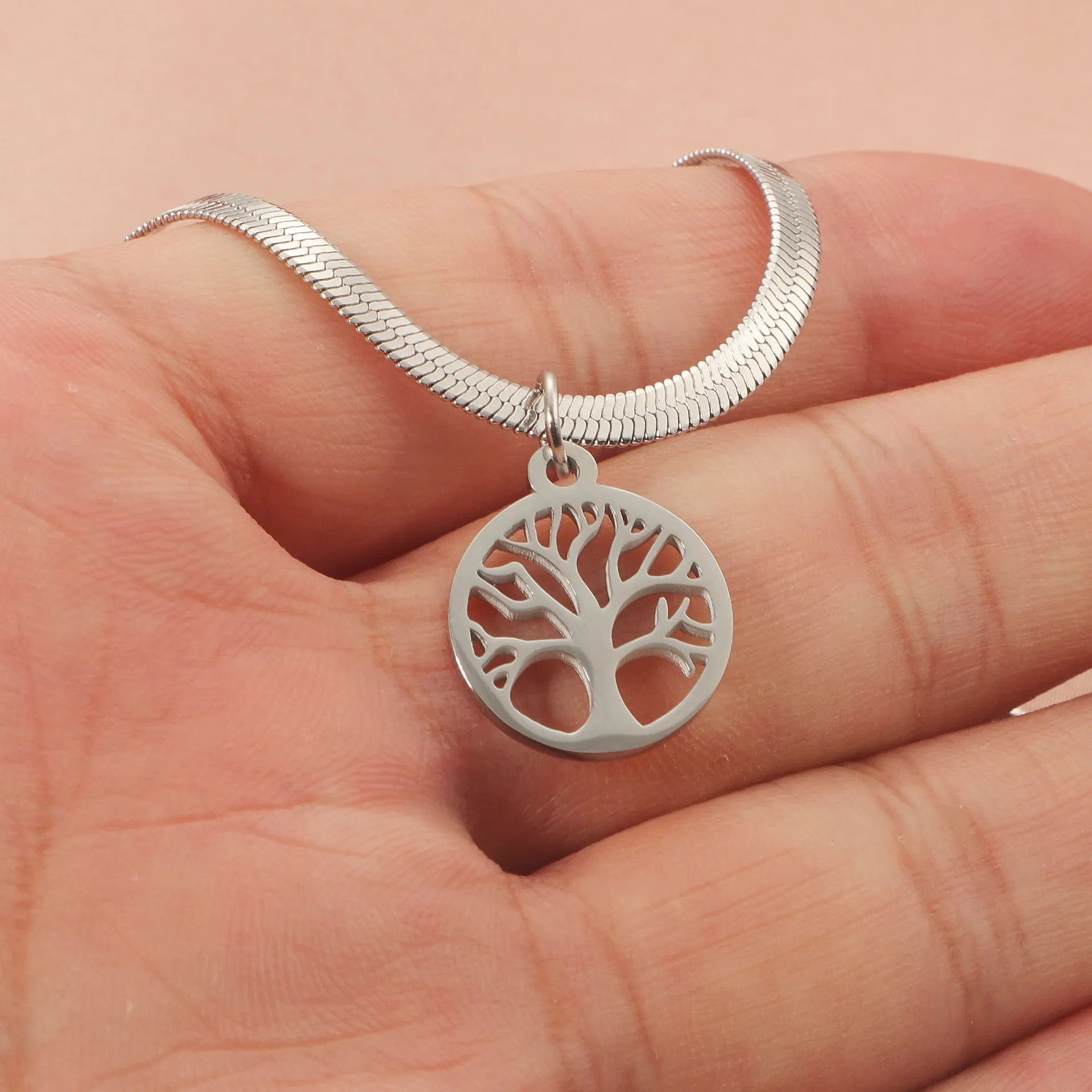 Stainless steel necklace with tree pendant on adjustable snake chain in gold and steel colours.