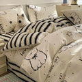 Cartoon dog pattern pure cotton four-piece quilt cover and bed sheet set on a bed
