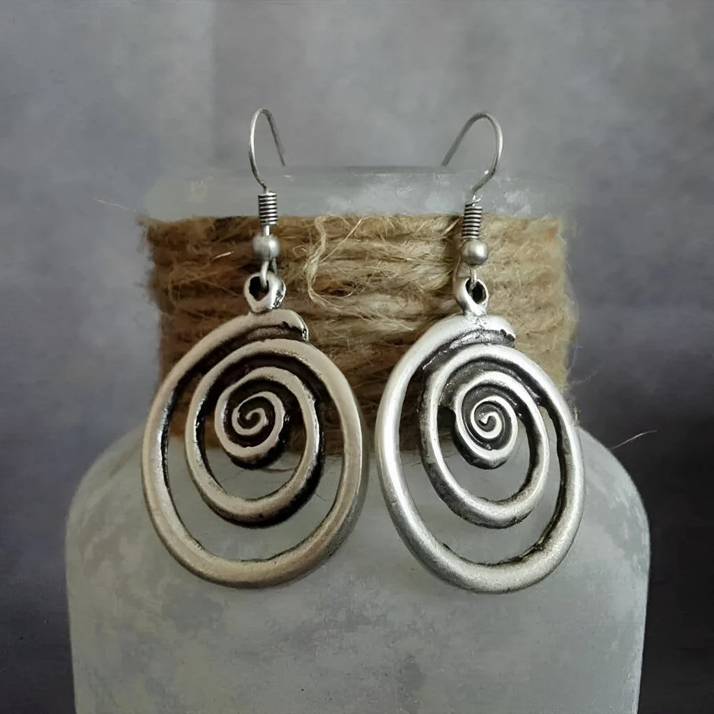 Silver geometric spiral earrings with a distressed retro finish, shown from the front.