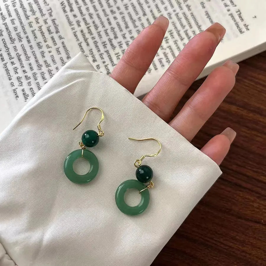 Green jade peace buckle shape earrings with zinc alloy construction and 14K gold plating