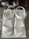 Women's beige peep toe ankle-strap buckle platform sandals with a fish mouth toe design on a wooden surface.