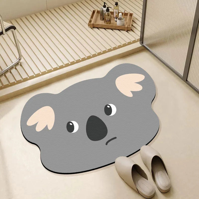 Colourful cartoon animal diatomite absorbent bathroom mat in alien shape on tiled floor.