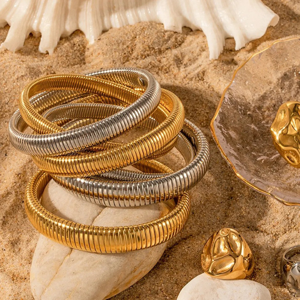 Women's titanium steel elastic bracelet with vertical stripe pattern and ring element in gold finish