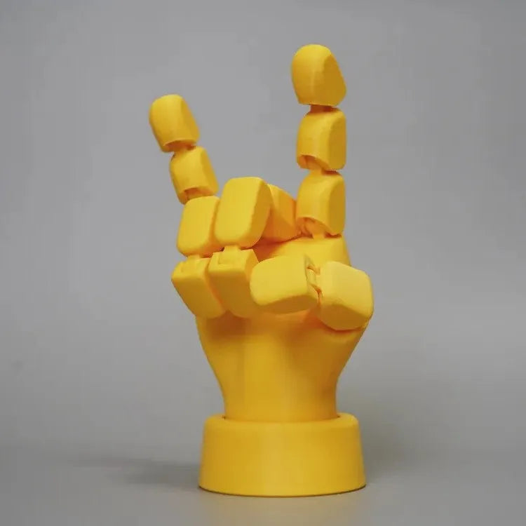 Yellow PLA plastic hand ornament with movable finger joints measuring 5 x 5.38 x 7.5 cm