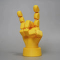 Yellow PLA plastic hand ornament with movable finger joints measuring 5 x 5.38 x 7.5 cm