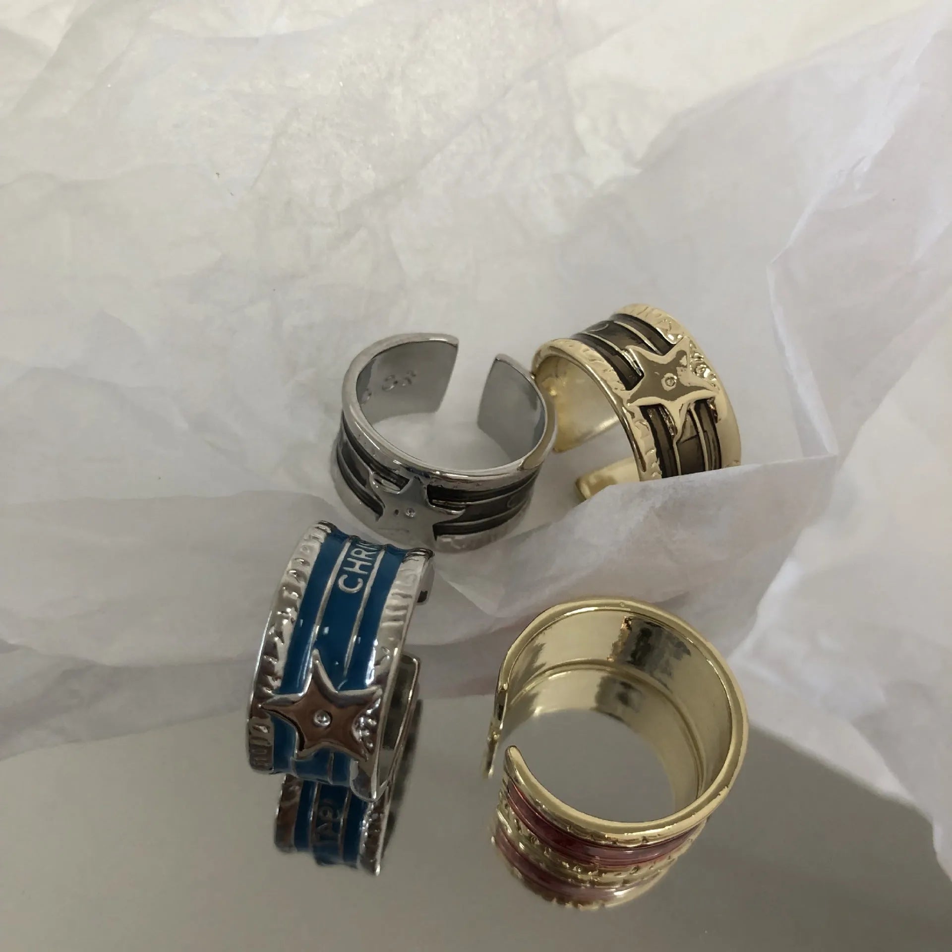 Geometric adjustable copper ring with a distressed finish in black, red, and blue colour options.