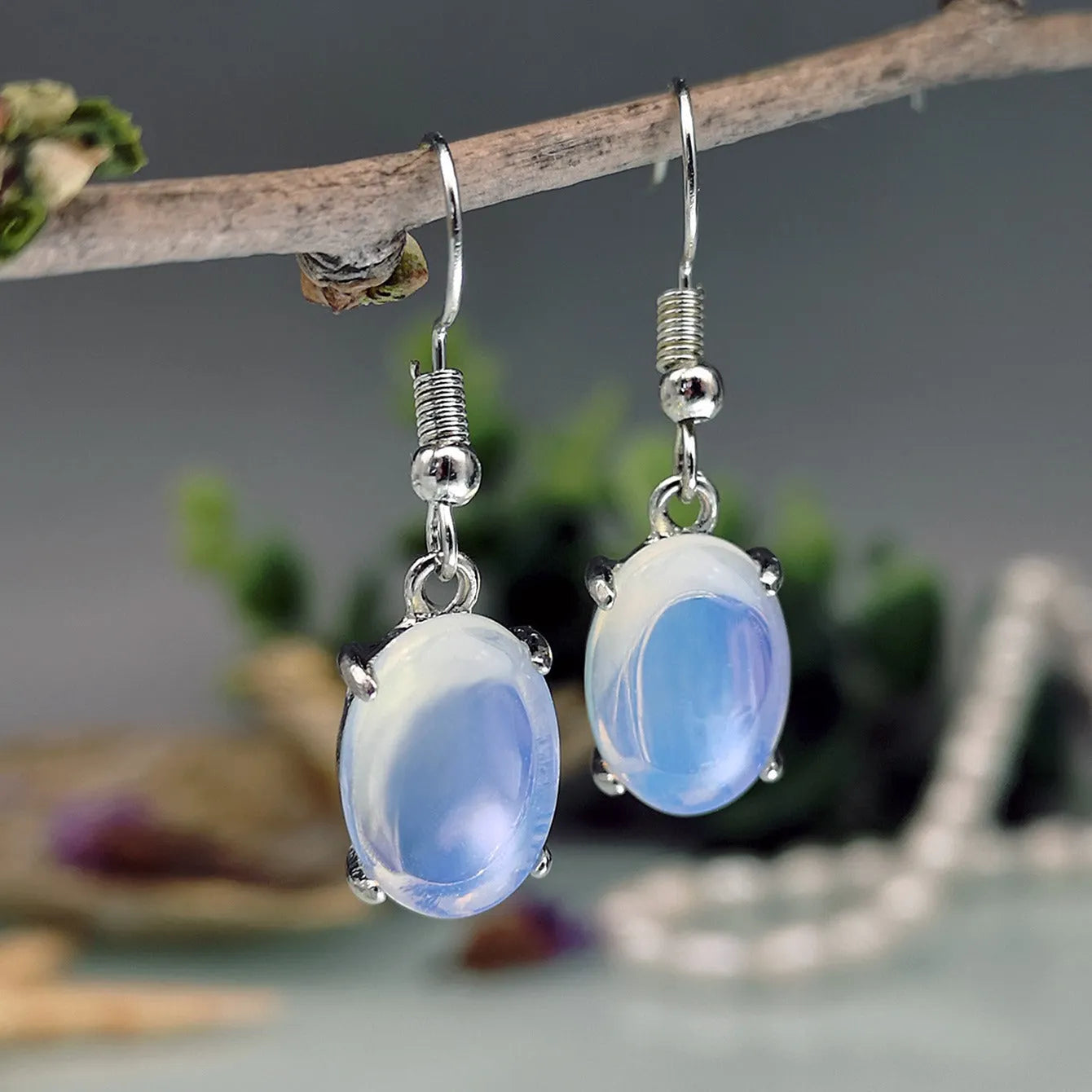Moonlight White opal earrings with electroplated alloy construction in drop shape design